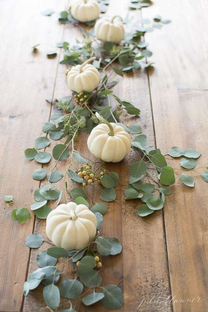 PHOTO: Use mini pumpkins and fresh greenery to create a simple and elegant table runner before adding the rest of your Thanksgiving decor.
