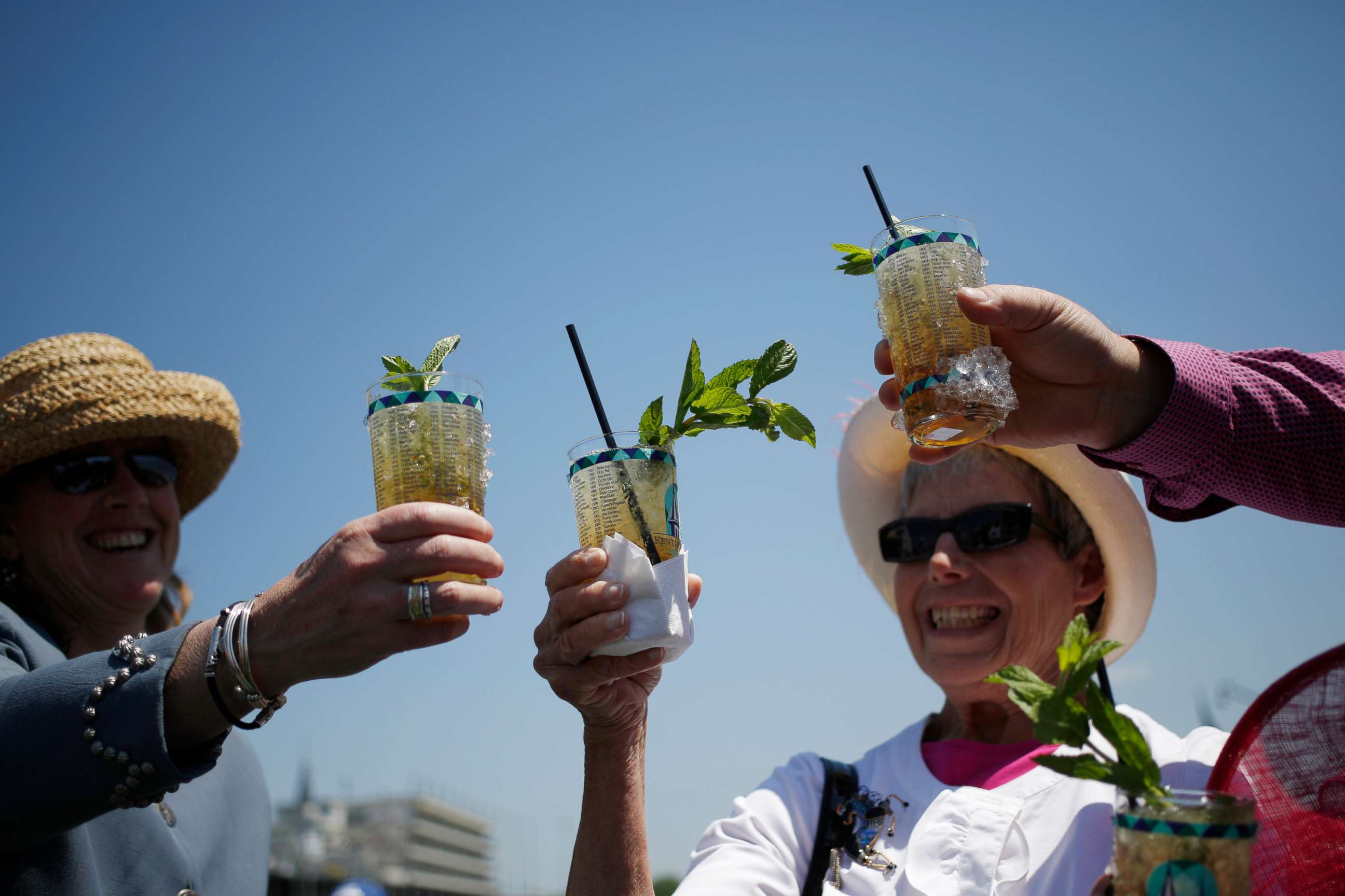 PHOTO: Racegoers who traveled to Churchill Downs from Colorado toast their mint julep bourbon cocktails while watching horse races on the eve of the Kentucky Derby in Louisville, Ky., May 1, 2015.
