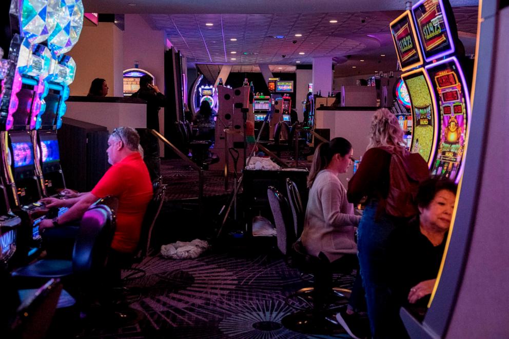 PHOTO: A cleaning cart is seen among slot machines at Mirage Hotel and Casino in Las Vegas, Nevada on March 13, 2020.