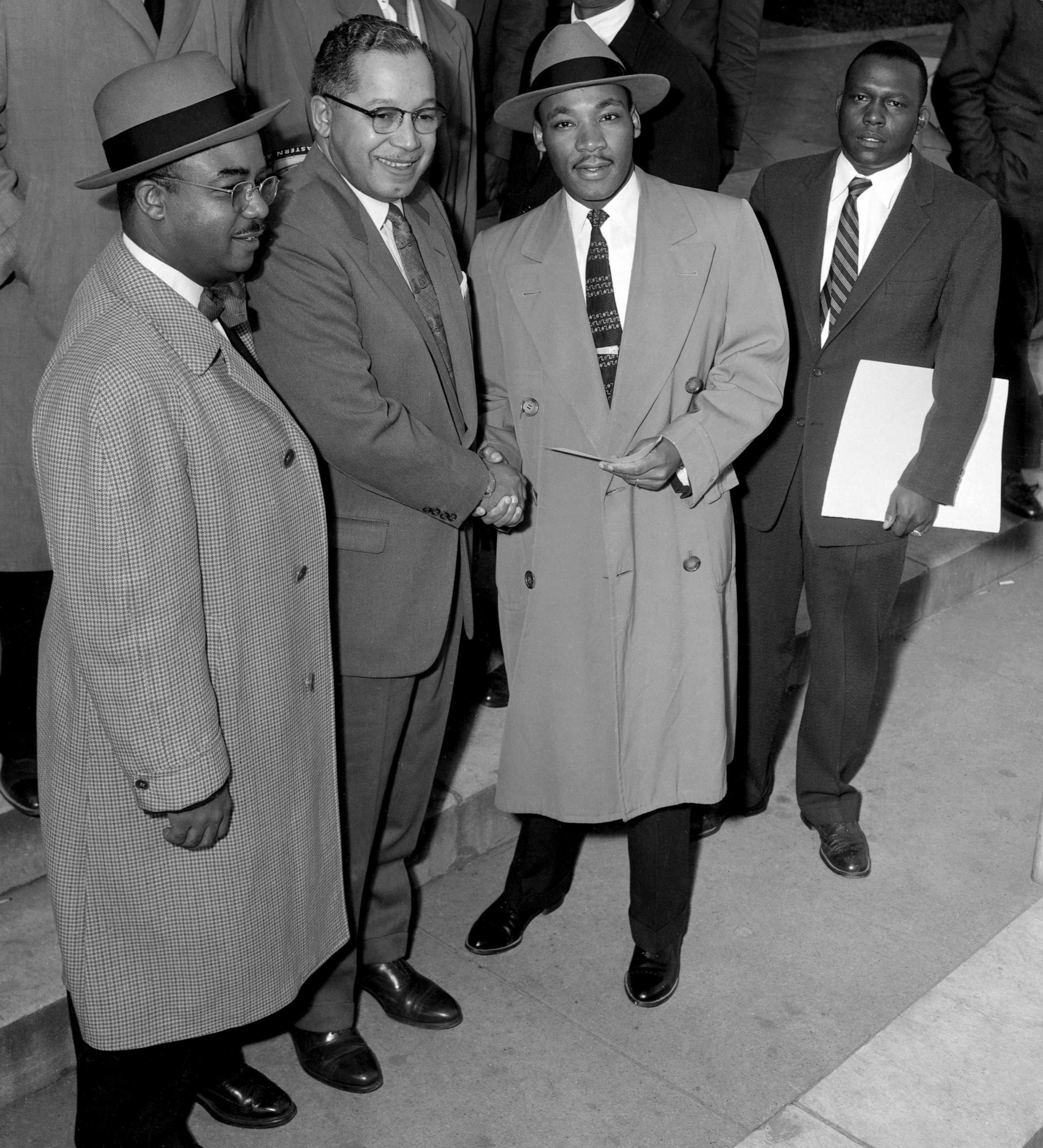 PHOTO: In this March 20, 1956 file photo James E. Huger, Gen. Secretary of Alphi Phi Alpha fraternity, presents a check for $1,000 to Rev. Martin Luther King as they arrived for the second day in court.