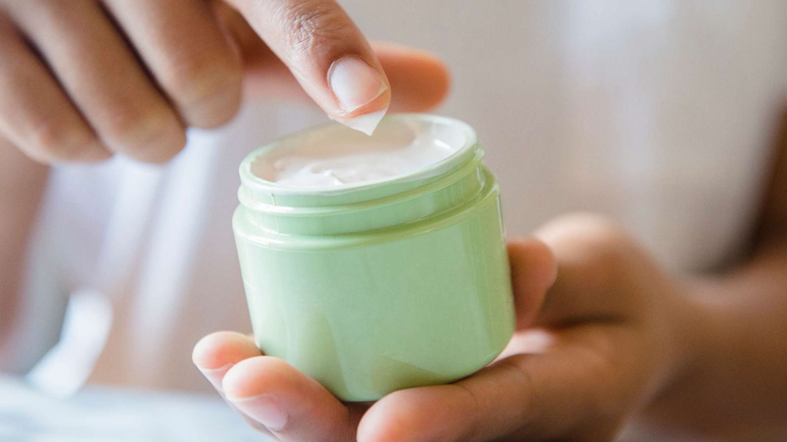 PHOTO: A woman applying moisturizer.