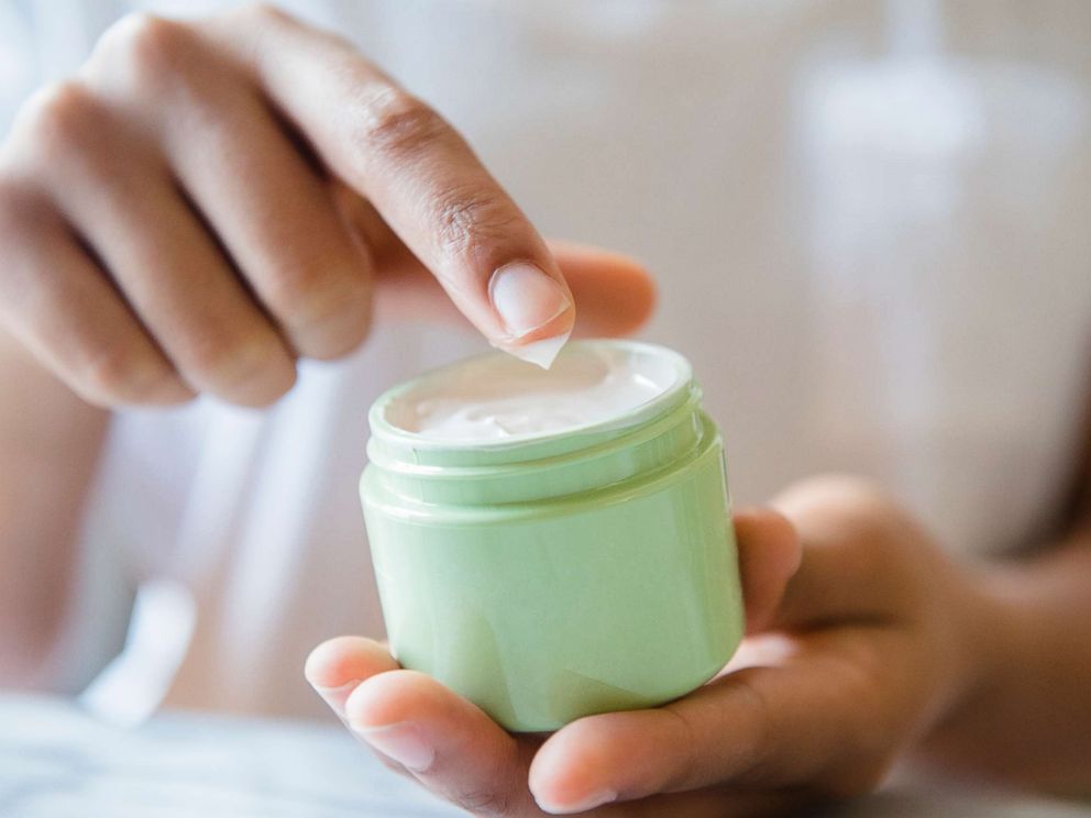PHOTO: A woman applying moisturizer.