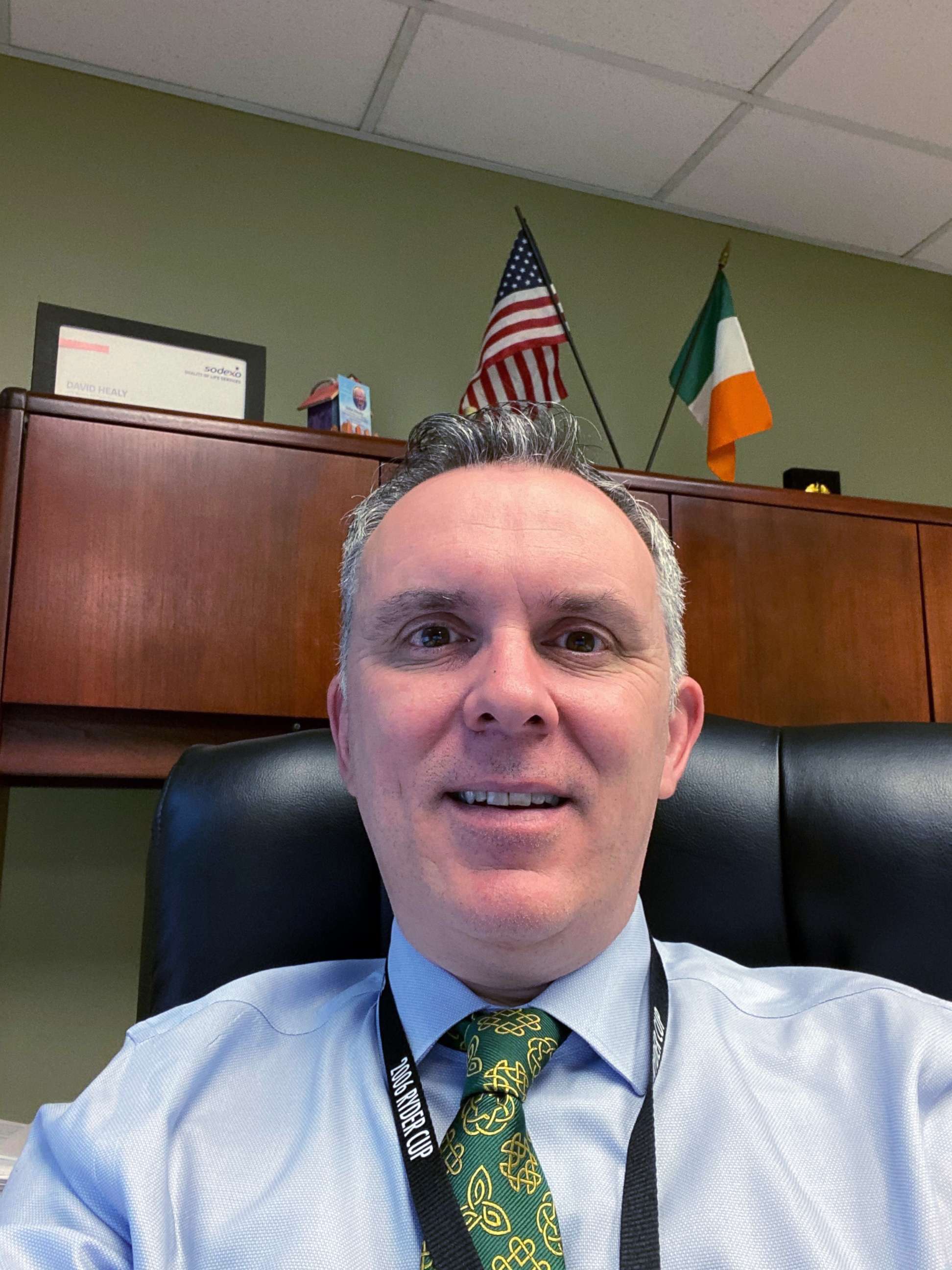 PHOTO: David Healy sits at his desk at Grady Hospital in Atlanta dressed for St. Patrick's Day on March 17, 2020.