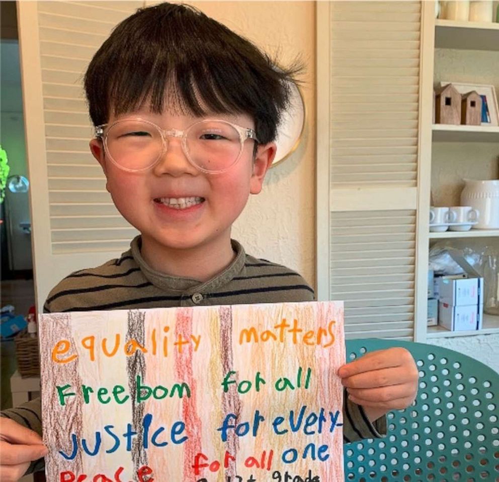 PHOTO: Bennett, 7, of Seattle, Washington, holds a sign about freedom and equality.