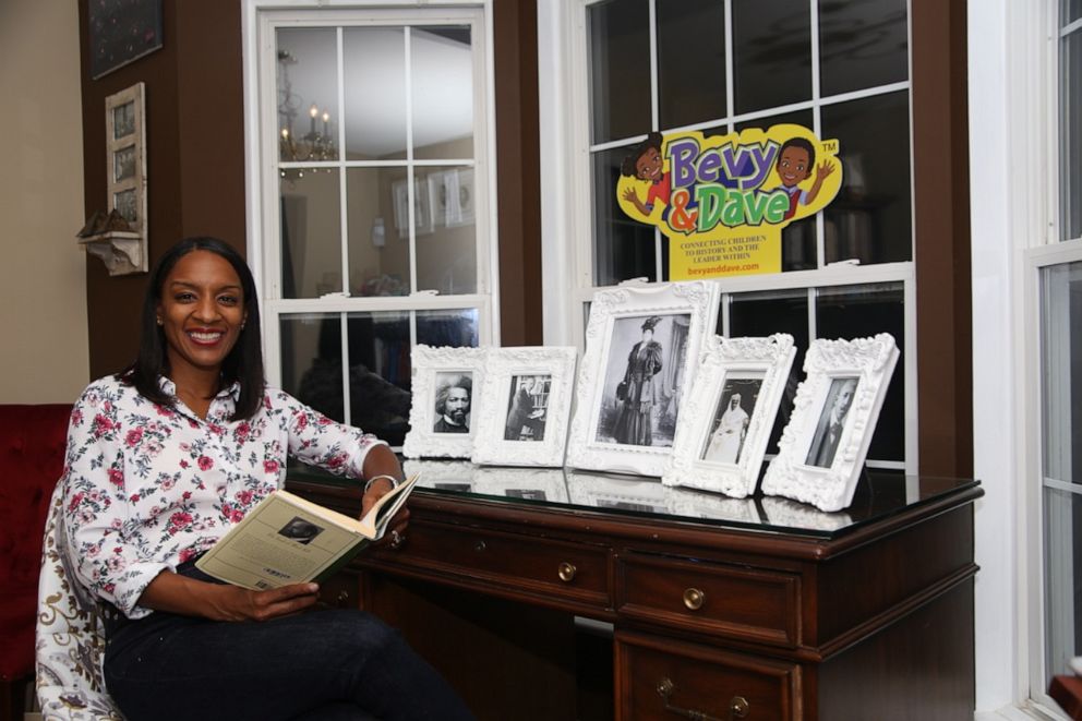 PHOTO: Tiffney Laing of Ashburn, Virginia, launched Bevy and Dave in hopes to help parents and educators explore Black history through the lens of leadership. In this photo Laing sits in her home beside photos of her ancestors.