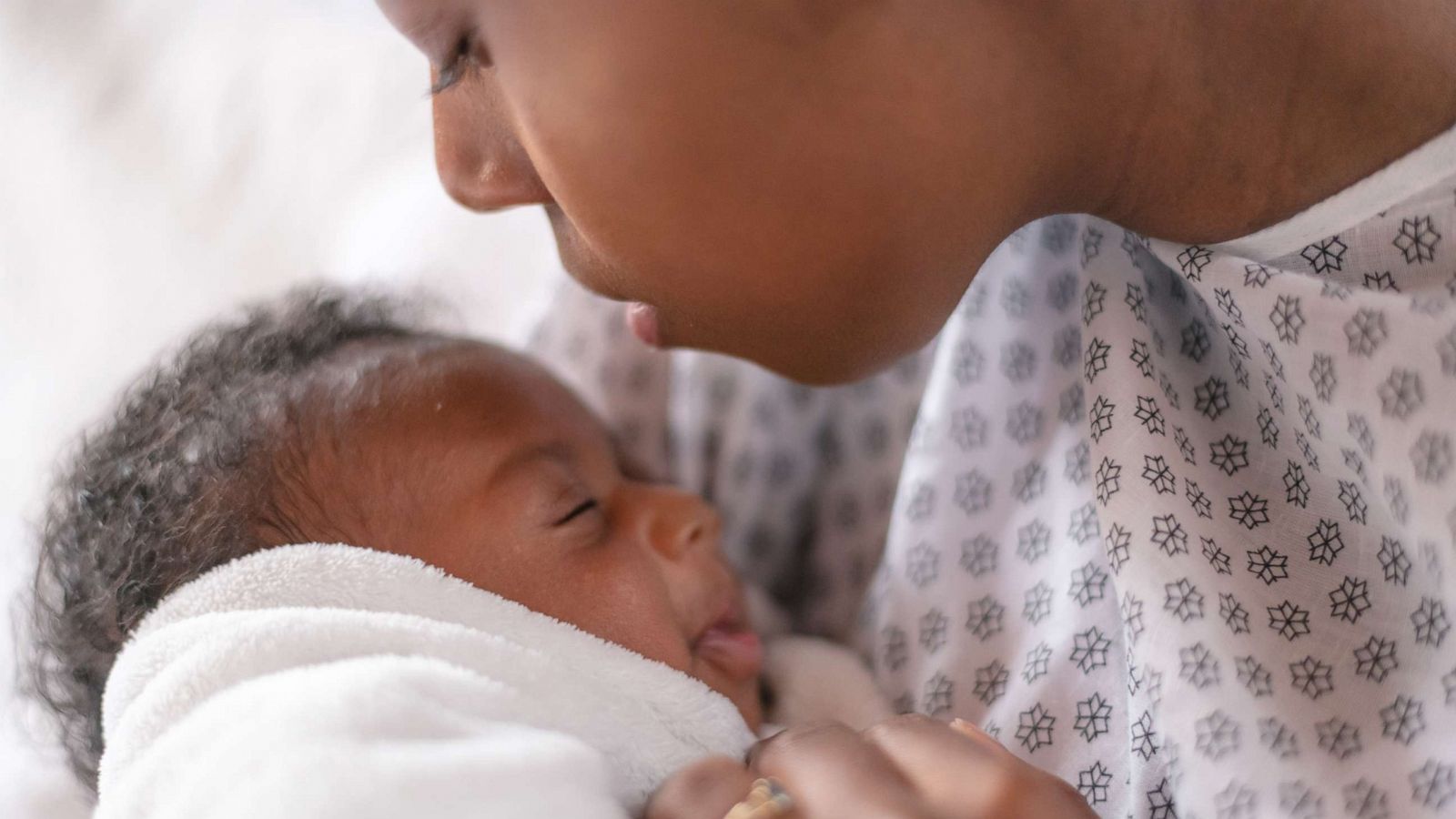 PHOTO: Stock photo of a young mother holding her newborn.