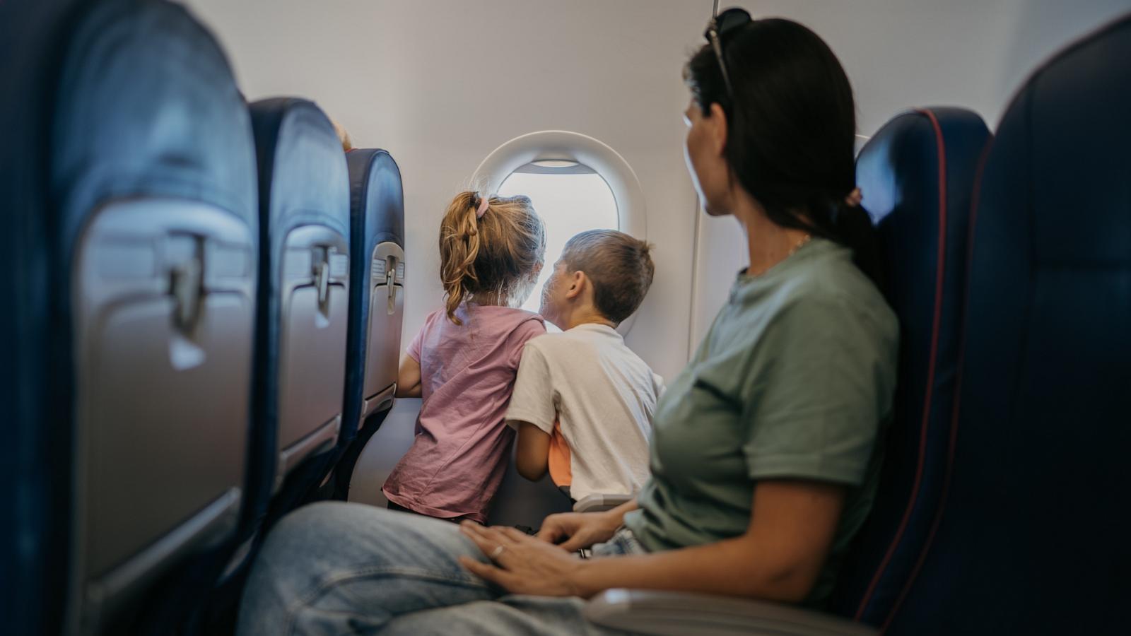 PHOTO: A mother with two children traveling on a plane.