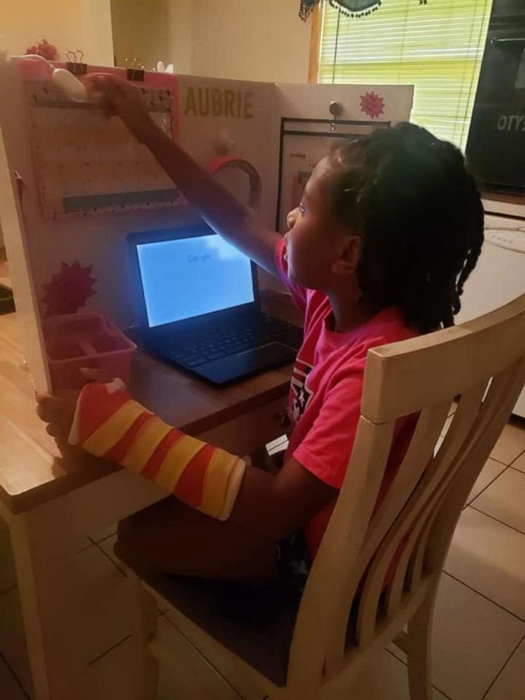 PHOTO: Angelina Harper, a special education teacher from Louisville, Kentucky, crafted work stations for each of her children, Aubrie, 8 and twins Paige and Peyton, 6. Seen in this photograph is Aubrie using her learn-from-home station.