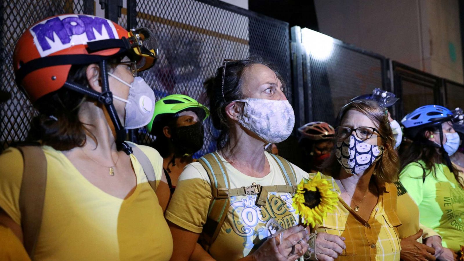 PHOTO: Mothers stand between federal law enforcement officials and demonstrators during a protest against racial inequality in Portland, Oregon, July 19, 2020.