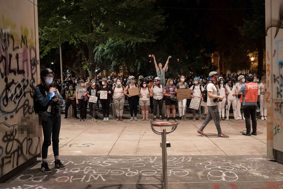 PHOTO: Moms form a human shield near the Federal Courthouse in Portland, Oregon, July 19, 2020, during another night of protests in the city.