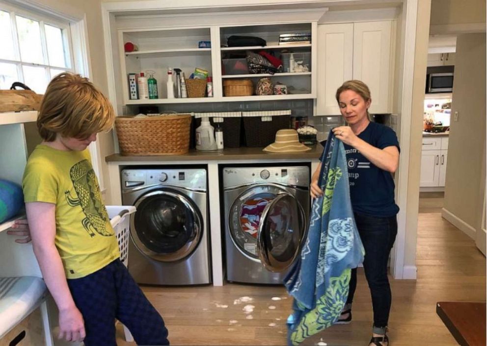 Oona Hanson shows her kids how to fold laundry during "Common Sense Camp."