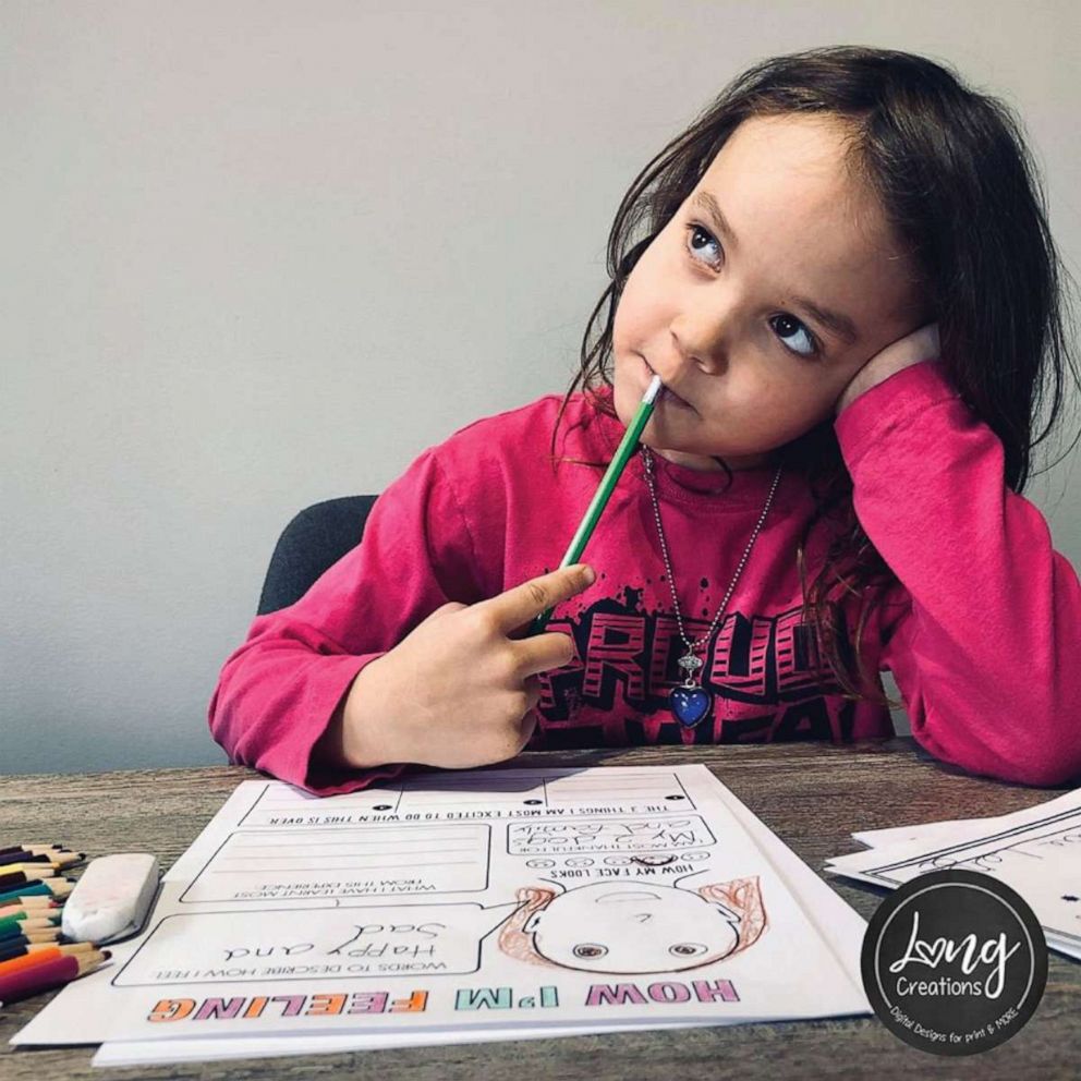 PHOTO: Natalie Long, from Alberta, Canada, has crafted free, downloadable, COVID-19 time capsule activities for every age from babies to adulthood. Here, Long's daughter Olivia, 8, works on a time capsule workbook of her own.