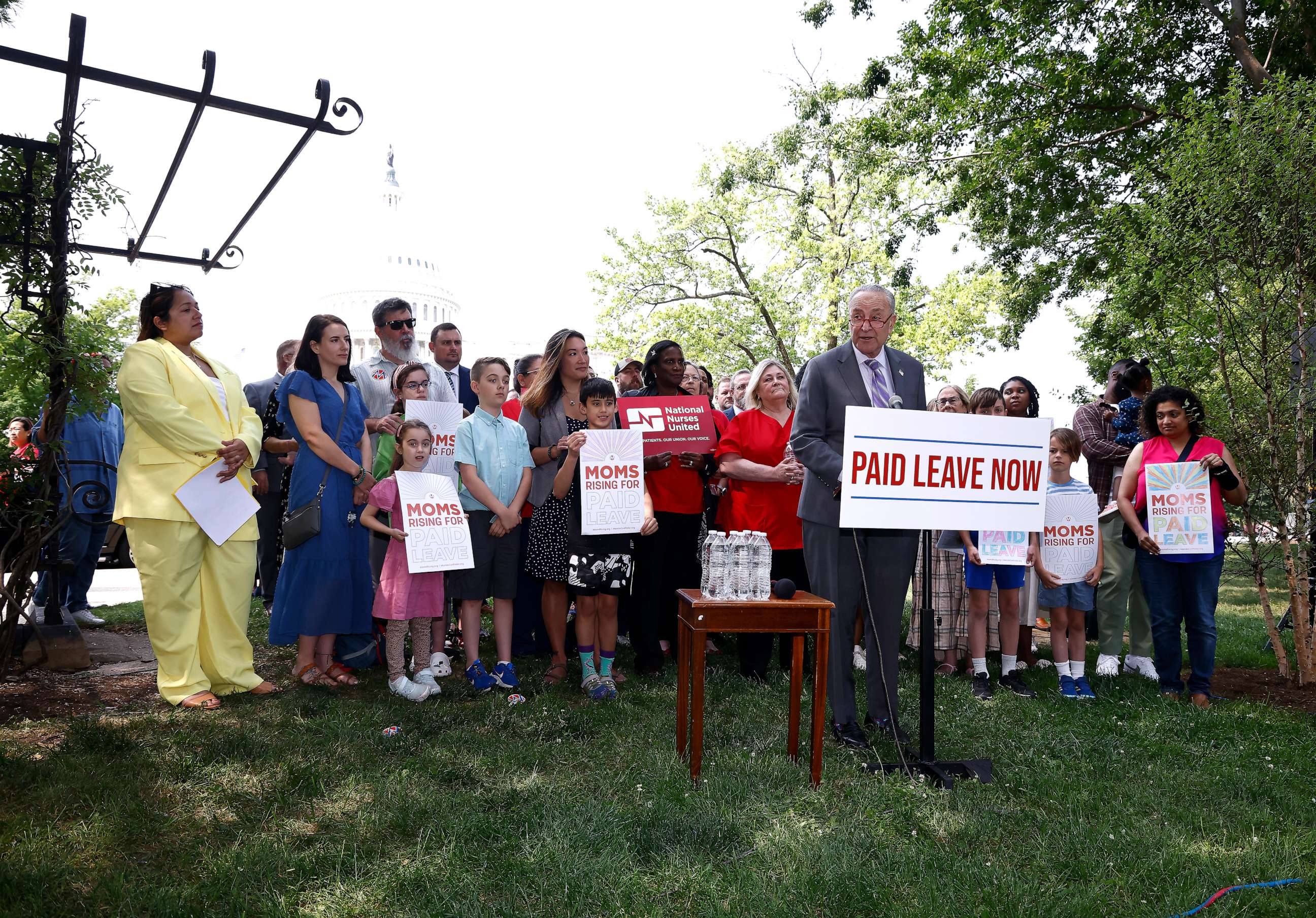 PHOTO: Senate Majority Leader Chuck Schumer joins MomsRising members and their kids at a picnic on Capitol Hill to urge Congress to make child care affordable, pass paid leave and support care infrastructure, May 17, 2023 in Washington.
