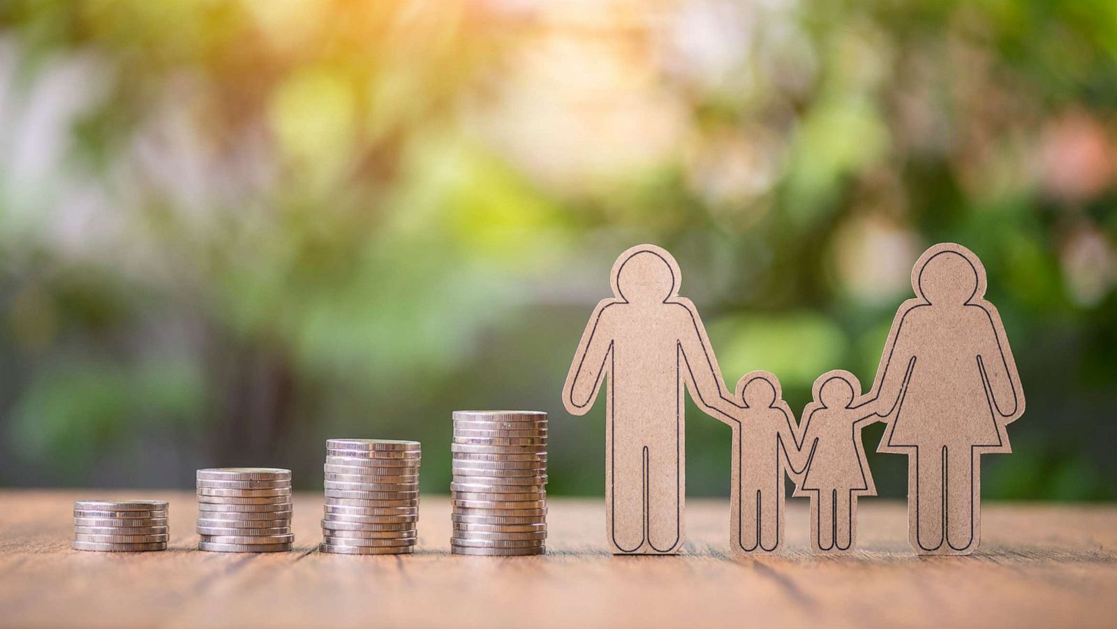 PHOTO: Stock photos of coin stacks with family paper cutout.