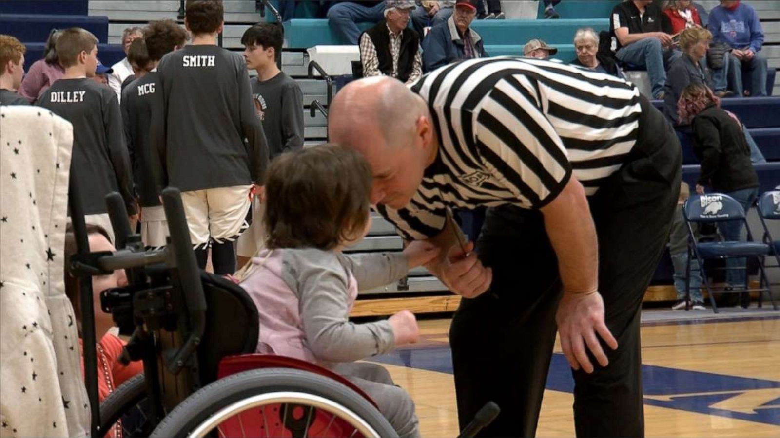 PHOTO: Finnley Foster watches her dad Pat Foster referee a high school basketball game in Great Falls, Montana, on Feb. 21, 2020.