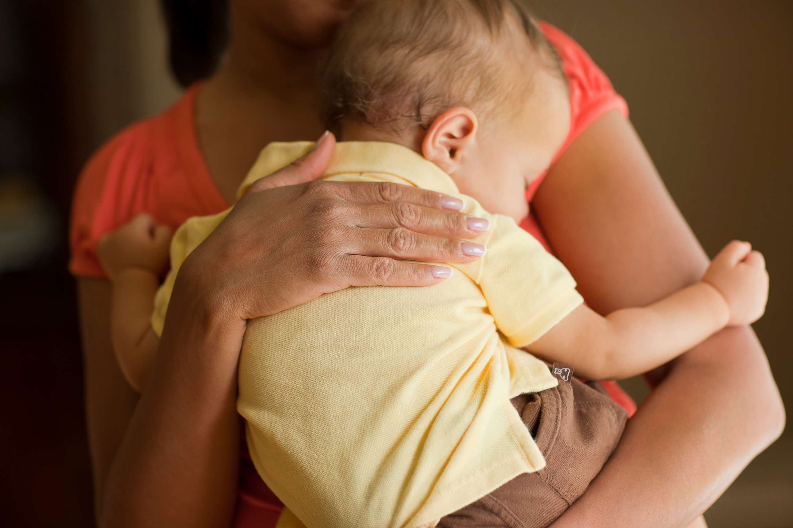 PHOTO: A mother holds a child.