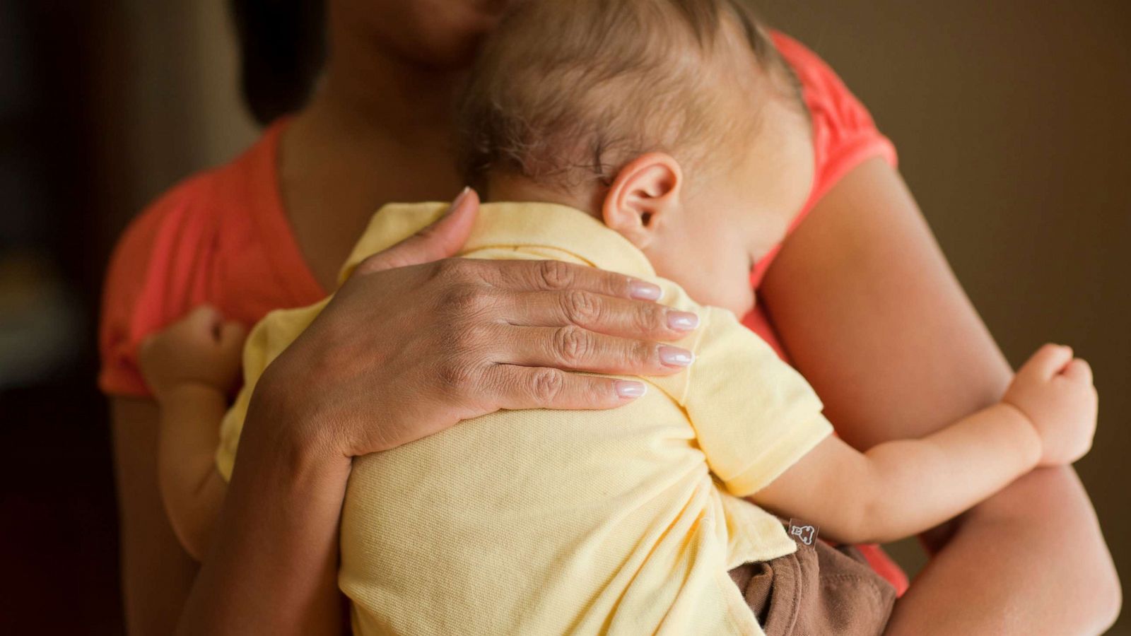 PHOTO: A mother holds a child.