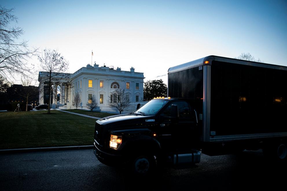 PHOTO: A moving truck departs outside of the West Wing of the White House at dawn, Jan. 20, 2021, in Washington.