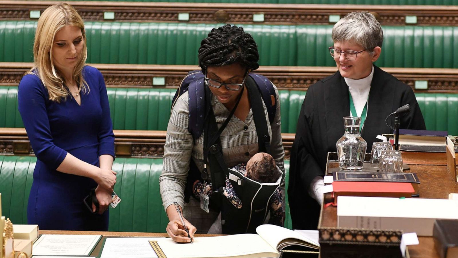 PHOTO: Britain's Conservative MP Kemi Badenoch, carrying her child, attends a lawmakers meeting and the swearing in ceremony, in London, Dec. 17, 2019.