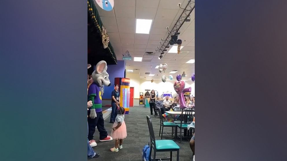 PHOTO: The toddler in this photo is Natyana Muhammad's daughter who is seen reaching out to high-five the Chuck E. Cheese character.