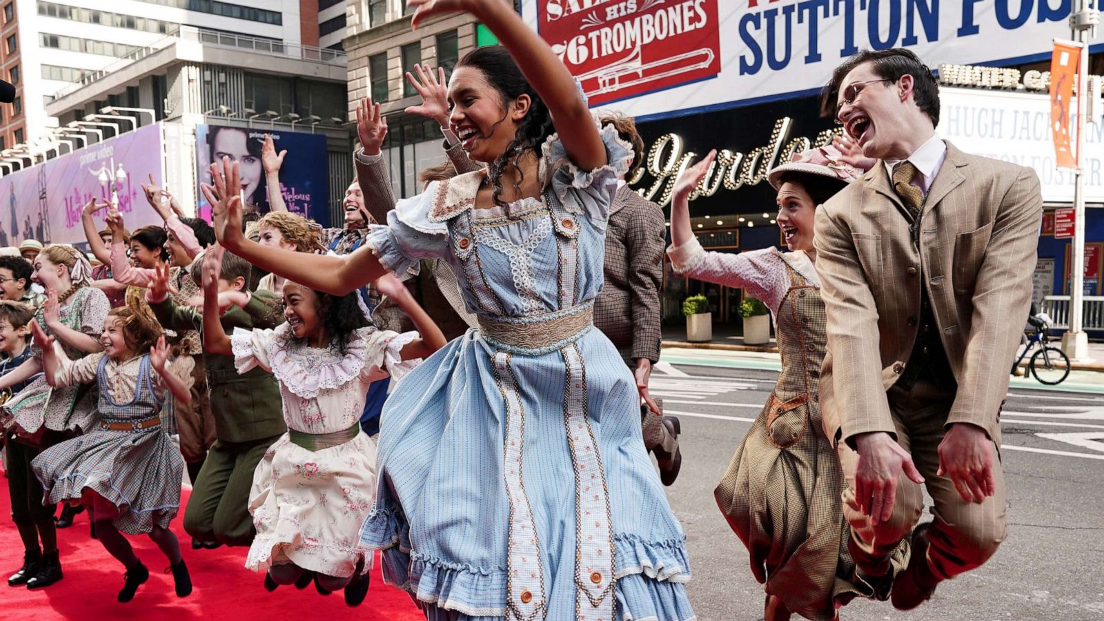 PHOTO: Actors dance as they pose for photos with the cast of Broadway show The Music Man across the street from the Winter Garden in New York City, Feb. 8, 2022.