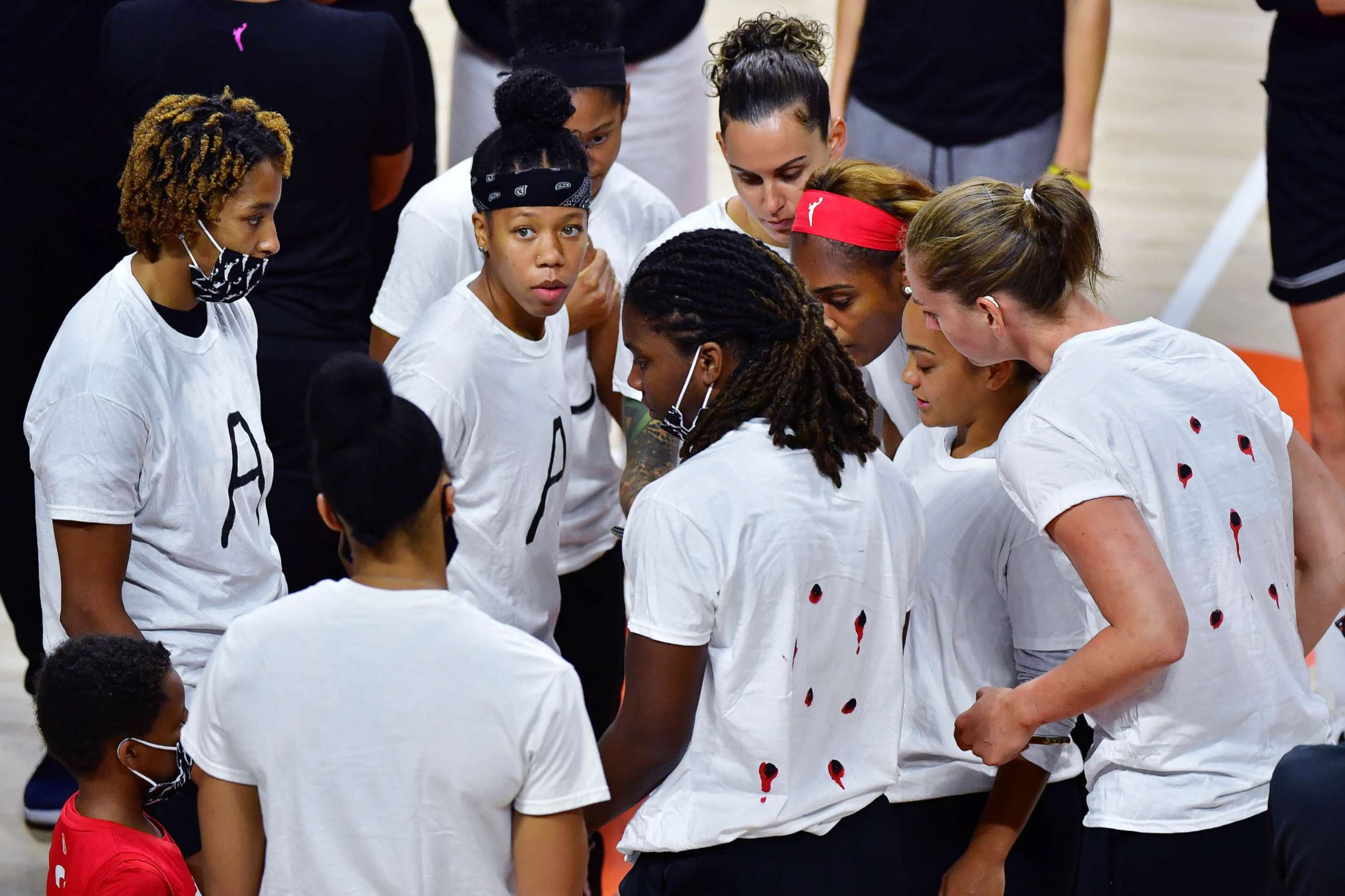 PHOTO: Members of the Washington Mystics WNBA team gather on court during the postponement announcement at Feld Entertainment Center on Aug. 26, 2020 in Palmetto, Fla.