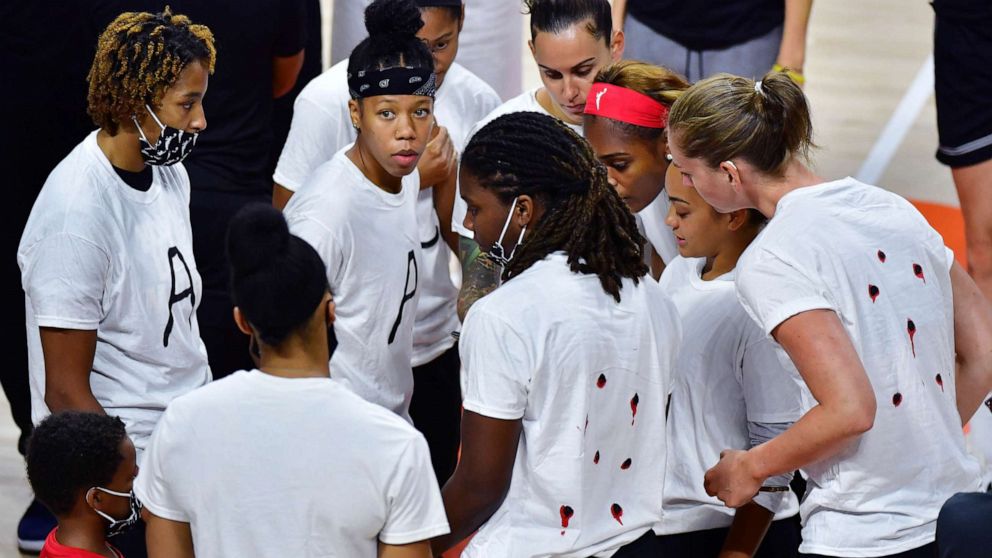 PHOTO: Members of the Washington Mystics WNBA team gather on court during the postponement announcement at Feld Entertainment Center on Aug. 26, 2020 in Palmetto, Fla.