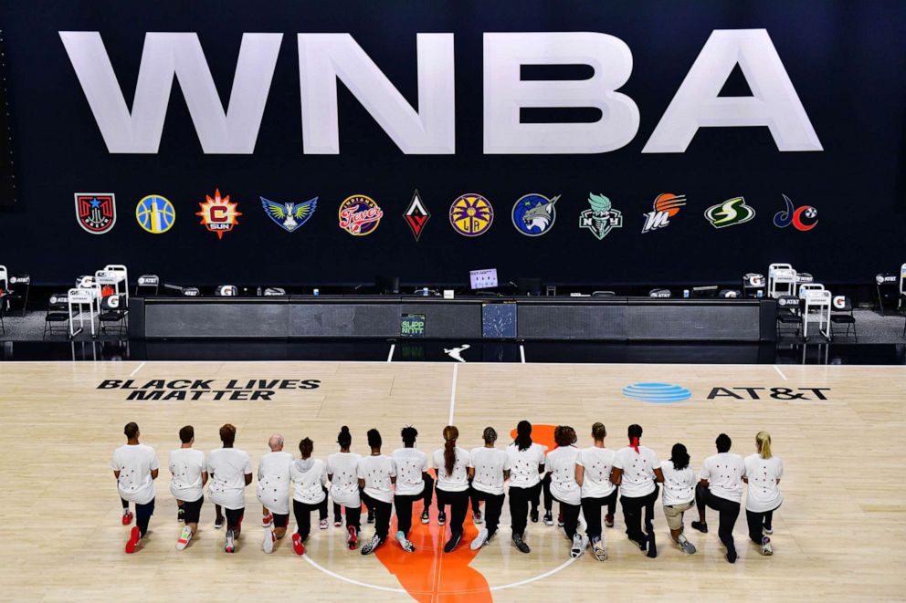 PHOTO: After the WNBA announcement of the postponed games, the Washington Mystics each wear white T-shirts with seven bullets on the back in protest of the shooting of Jacob Blake by Kenosha, Wisconsin police, Aug. 26, 2020, in Palmetto, Fla.