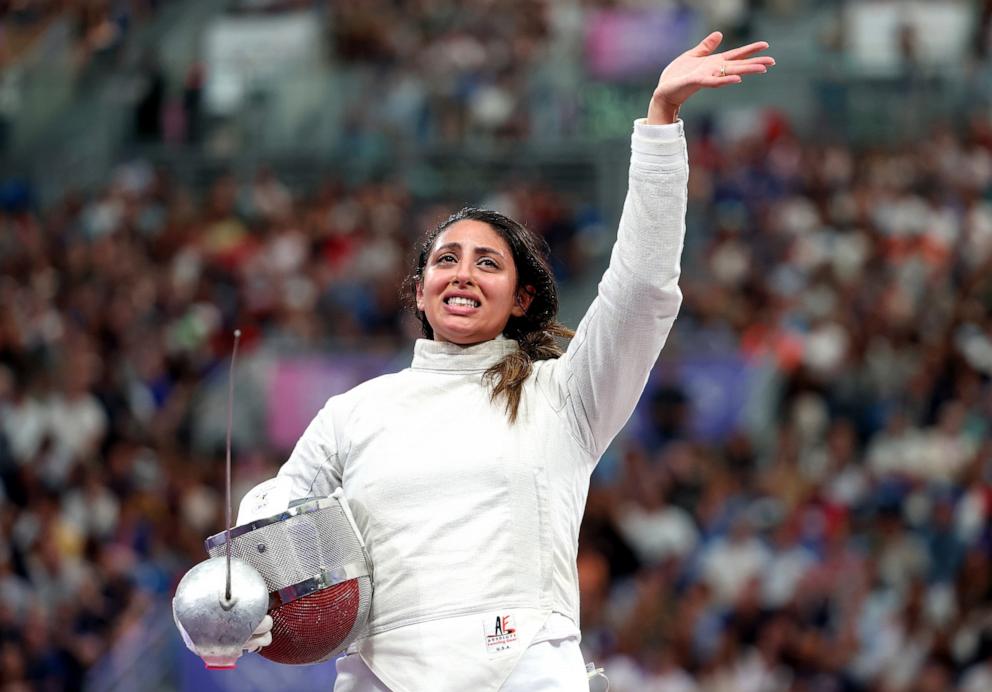 PHOTO: Nada Hafez of Team Egypt applauds fans after her victory against Elizabeth Tartakovsky of Team United States in the Fencing Women's Sabre Individual Table of 32 on day three of the Olympic Games Paris 2024 at Grand Palais on July 29, 2024 in Paris.