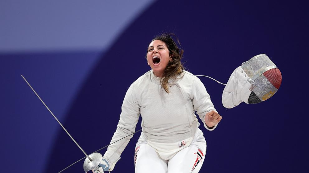 PHOTO: Nada Hafez of Team Egypt celebrates her victory against Elizabeth Tartakovsky of Team United States in the Fencing Women's Sabre Individual Table of 32 on day three of the Olympic Games Paris 2024 at Grand Palais on July 29, 2024 in Paris.