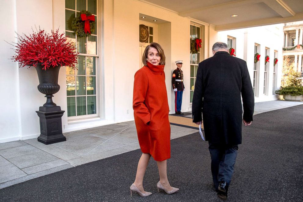 PHOTO: House Minority Leader Nancy Pelosi, left, speaks to a reporter as she and Senate Minority Leader Sen. Chuck Schumer walk back into the West Wing of the White House in Washington, Dec. 11, 2018.