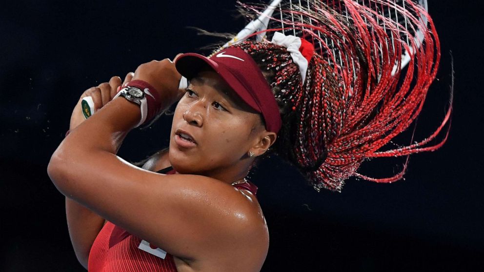 PHOTO: Japan's Naomi Osaka plays in the Tokyo 2020 Olympic Games women's singles third round tennis match at the Ariake Tennis Park in Tokyo, July 27, 2021.