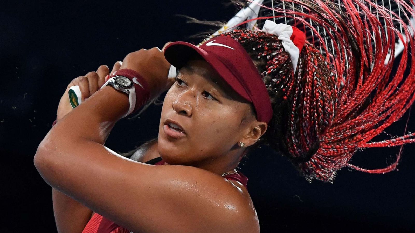 PHOTO: Japan's Naomi Osaka plays in the Tokyo 2020 Olympic Games women's singles third round tennis match at the Ariake Tennis Park in Tokyo, July 27, 2021.