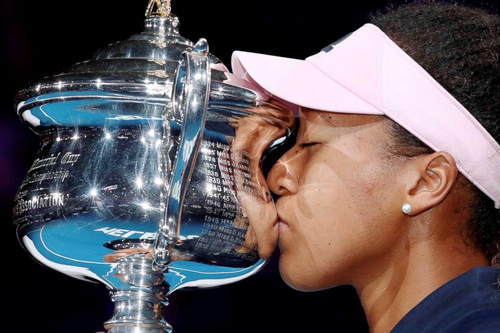PHOTO: Naomi Osaka kisses her trophy after winning her match against Czech Republic's Petra Kvitova in Melbourne, Australia, Jan. 26, 2019.