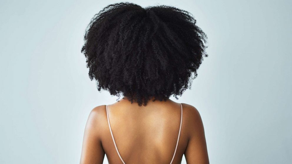 PHOTO: An undated stock photo depicts a young woman with curly hair.