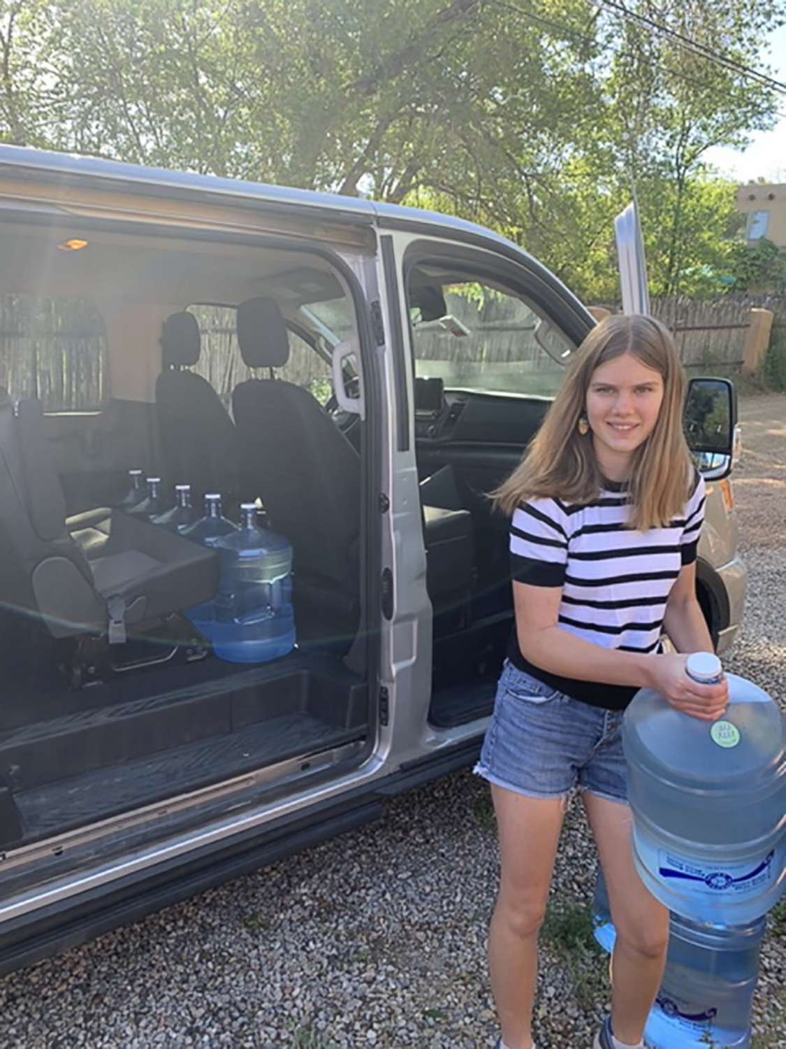 PHOTO: Daisy Russell loads water jugs into a van full of supplies in Santa Fe, N.M., before delivering them with her family to the Navajo reservation in Window Rock, Ariz.