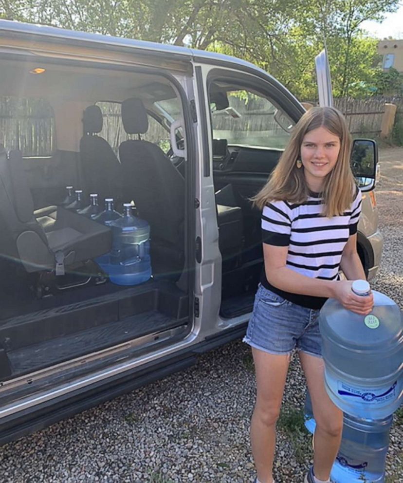 PHOTO: Daisy Russell loads water jugs into a van full of supplies in Santa Fe, N.M., before delivering them with her family to the Navajo reservation in Window Rock, Ariz.