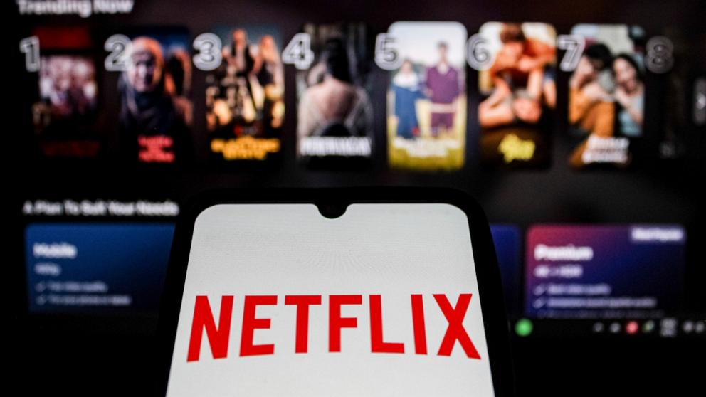 PHOTO: The Netflix Logo is displayed on a smartphone screen with the Netflix website in the background.