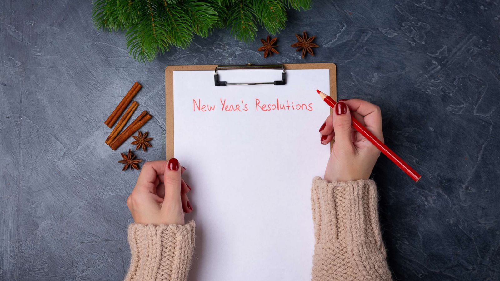 PHOTO: A woman holds a pencil in front of an empty list of New Year's resolutions in an undated stock photo.