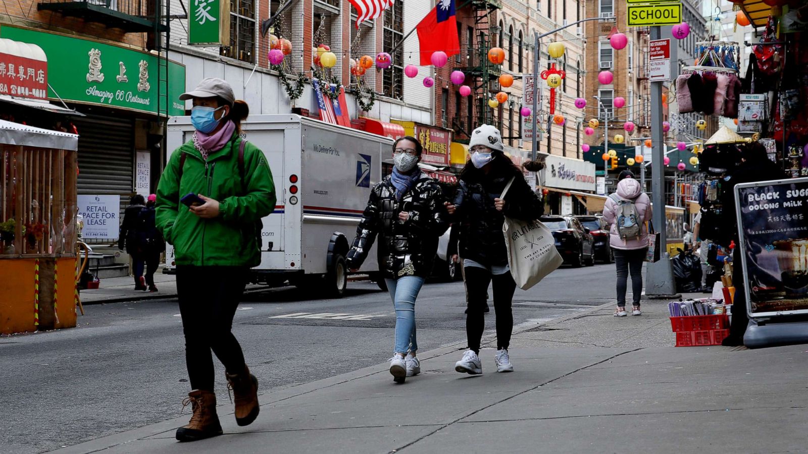 PHOTO: People walk through the streets of Chinatown on March 01, 2021, in New York.