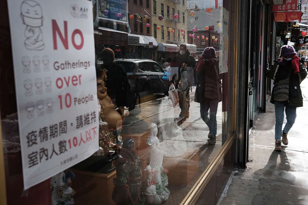 PHOTO: People walk through Chinatown on the eve of the Lunar New Year holiday on Feb. 11, 2021, in New York.