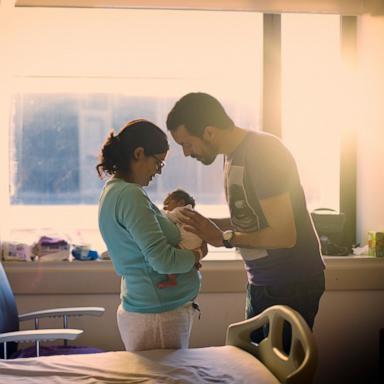 PHOTO: Stock photo of parents with their newborn.