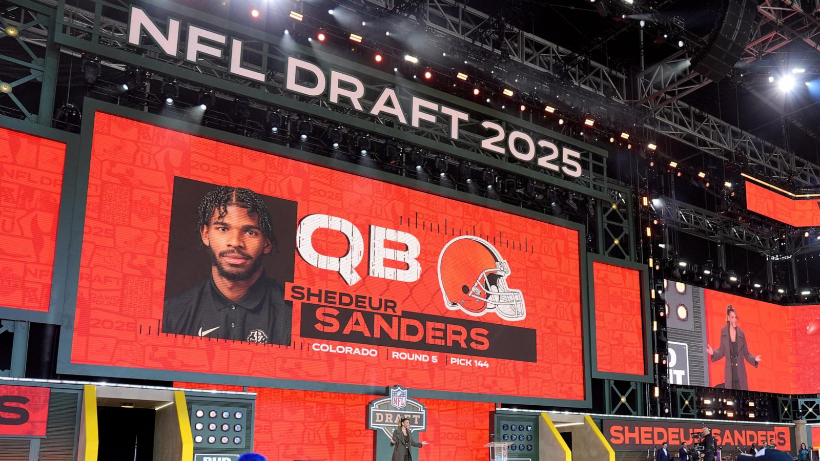 PHOTO: A screen shows Colorado quarterback Shedeur Sanders' name after being selected by the Cleveland Browns with the 144th overall pick during the fifth round of the 2025 NFL Draft on April 26, 2025 in Green Bay, Wisconsin.