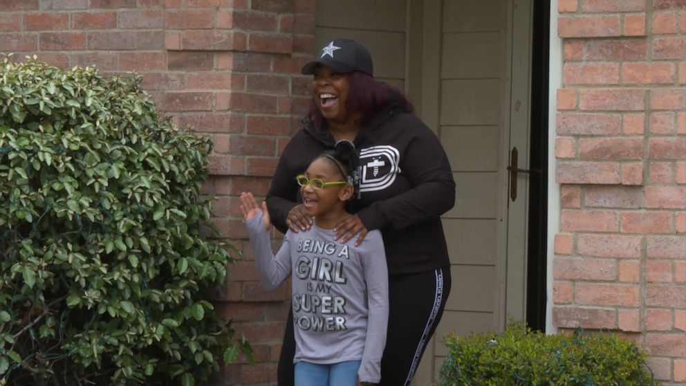 PHOTO: Hurtado's student Nia Mays, 2nd grade, and her mom Kisha Montgomery outside their house waving goodbye to Hurtado.