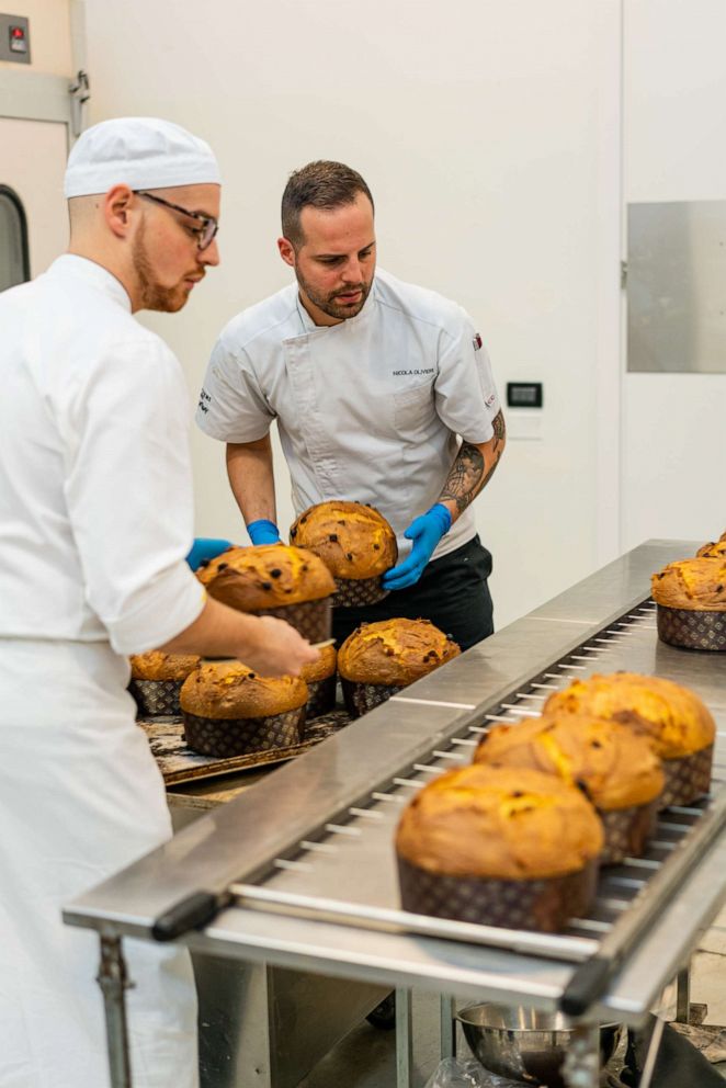 PHOTO: Nicola Olivieri moves fresh-baked panettone onto a cooling rack inside his family-owned bakery.