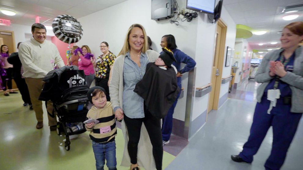 PHOTO: Nicole Blodgett carries her son, Bodie, through the hallway during his graduation ceremony at the Neonatal Intensive Care Unit at UPMC Children's Hospital of Pittsburgh.