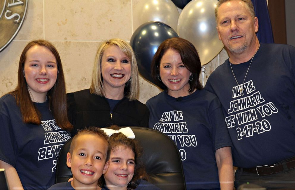 PHOTO: Nike Schwartz, 8, center, poses with his family and judge on his adoption day, Feb. 17, 2020.