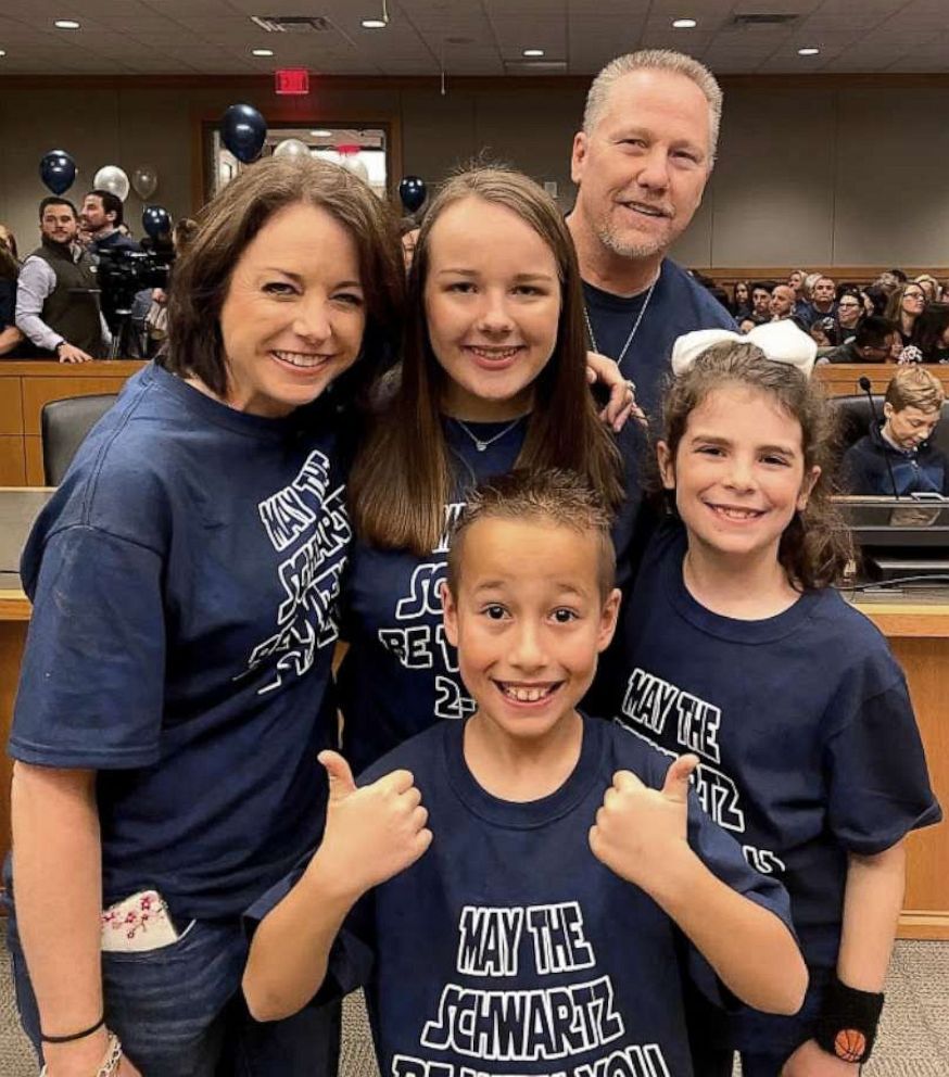 PHOTO: Nike Schwartz, 8, center, poses with his family on his adoption day, Feb. 17, 2020