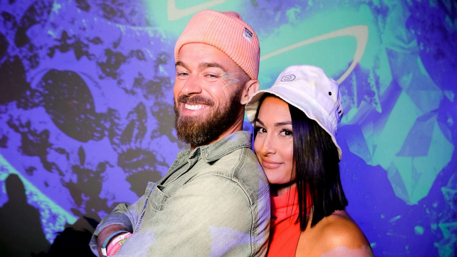 Nikki Bella touches her growing bump as she puts on loved-up display with  fiance Artem Chigvintsev