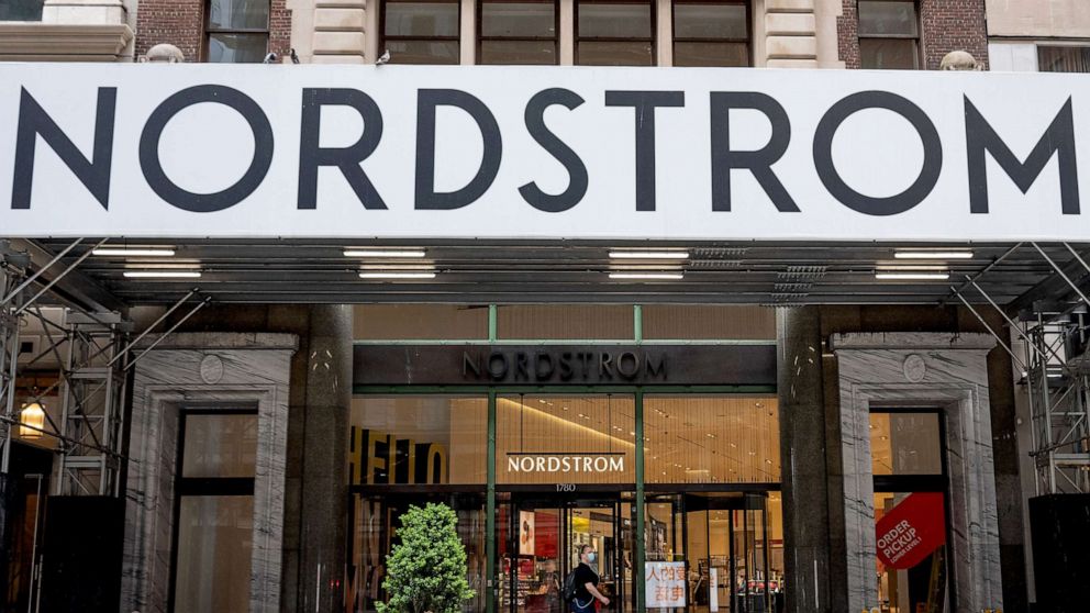 PHOTO: In this May 28, 2020, file photo, a woman wearing a mask walks past a Nordstrom store in New York.